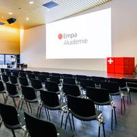 Several chairs are set up in an auditorium