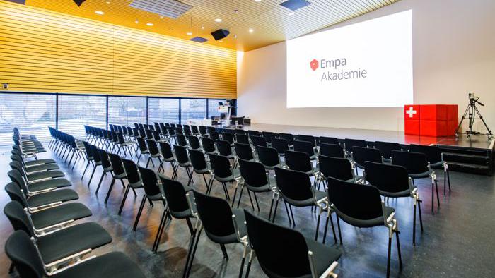 Several chairs are set up in an auditorium