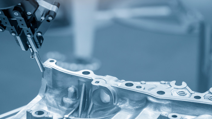 The robot for manufacturing  the aluminum automotive part .The automotive part quality control concept.