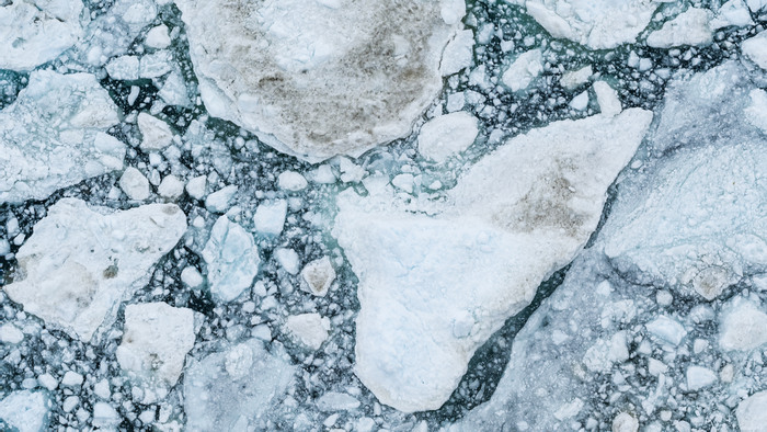 Icebergs drone aerial image top view - Climate Change and Global Warming. Icebergs from melting glacier in icefjord in Ilulissat, Greenland. Arctic nature ice landscape in Unesco World Heritage Site.