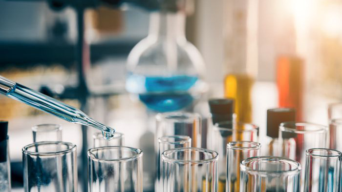 Chemicals are dropped into containers using a pipette